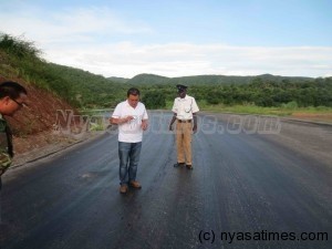 Chinese taking picture of the damaged Chitipa-Karonga road