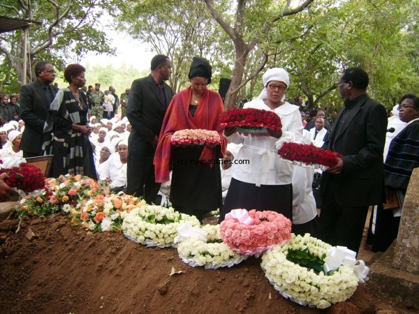 Chanthunya's younger sisters laying wreaths