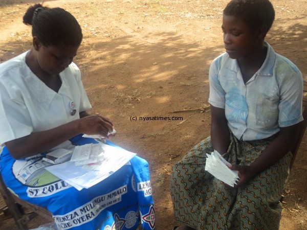A Nurse equipping an adolescent girl on female condom