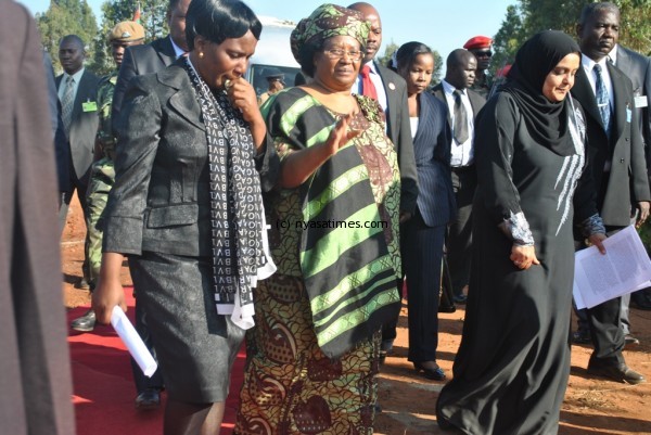 Leah Banda (left) holding back her tears as she walks to the podium with the president. Pic by Trouble Ziba