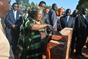 President Joyce Banda laying a foundation stone Mrs Lea Banda's house at Area 4, Katoto Low density in Mzuzu