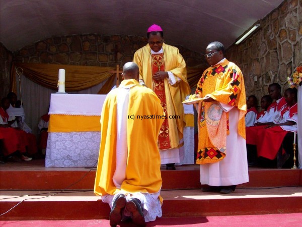 His Grace ArchBishop giving authority to the new parish priest