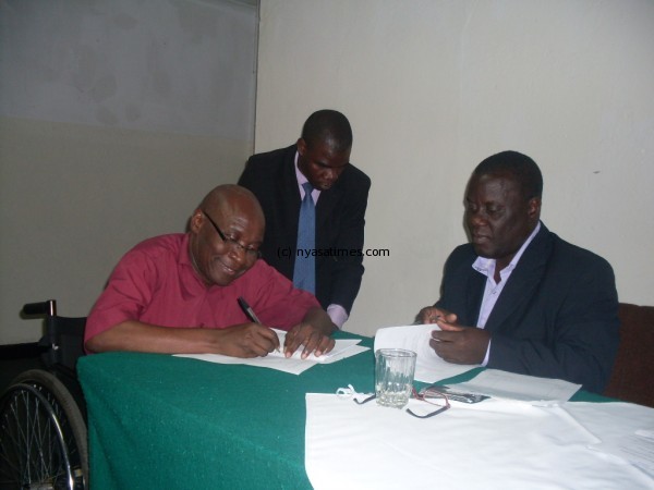 BPAM Secretary Alfred Msadala signing the document.