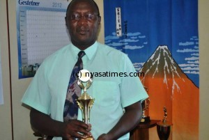 Mary Mount Girls' Secondary School Headteacher John Banda displaying the trophy (2)