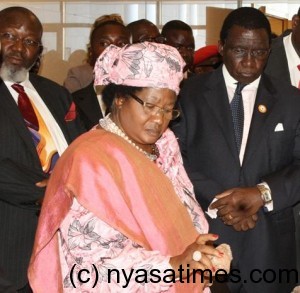 President Mrs Joyce Banda Appriciating a stone at the Launch of the Mining Governance and Grouth Support Project.