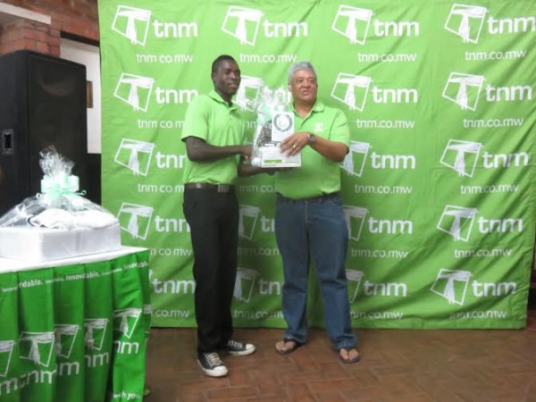 A-Div champ Canaan Paul gets his prize from TNM Chief Operating Officer Eric Valentine.