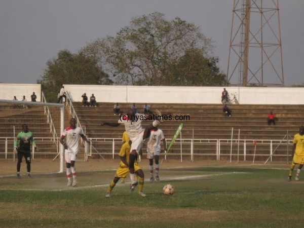 A Lions' defender stretches full length to clear the ball from dange