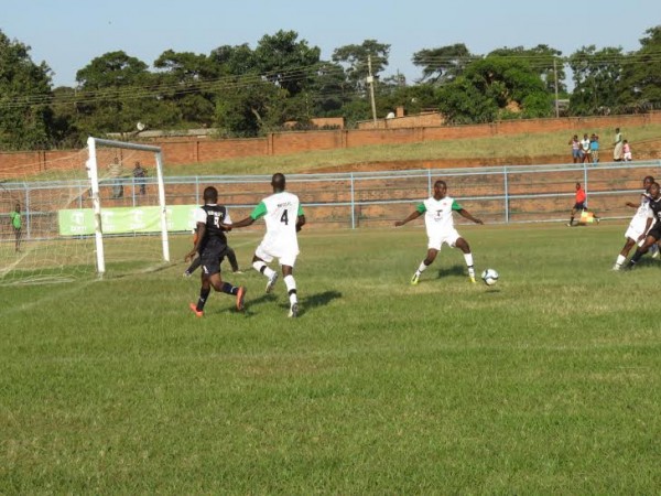 A Mafco defender clears the ball from danger.