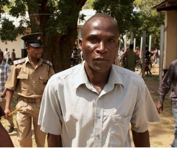  Eric Aniva known as a “hyena” arrives at the Magistrate Court in Nsanje (AFP Photo/Eldson Chagara) 