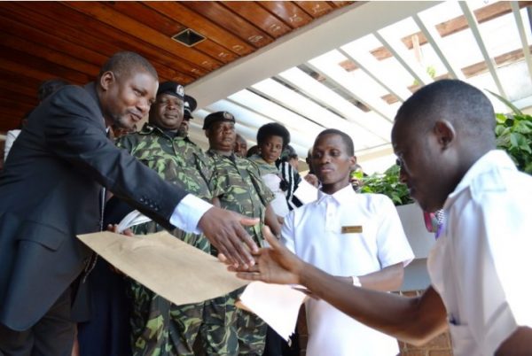 Nyson Sekani hands over petition to Lilongwe DC Charles Makanga as Union vice president Iron Kathonyeza looks on