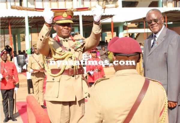 General Supuni Phiri receives a sword of command from deputy minister of defence instead of his predecessor
