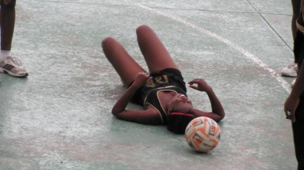 A Tigresses player slipped on the water logged court court yard.