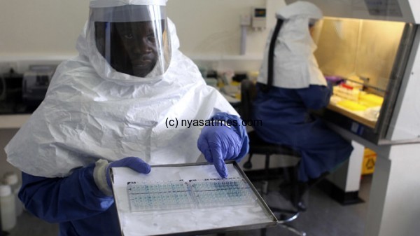 A doctor displays collected samples of the Ebola virus
