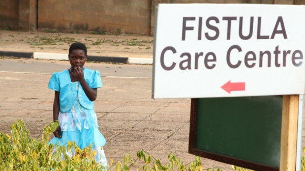 A fistula patient, stands outside a clinic in Malawi.