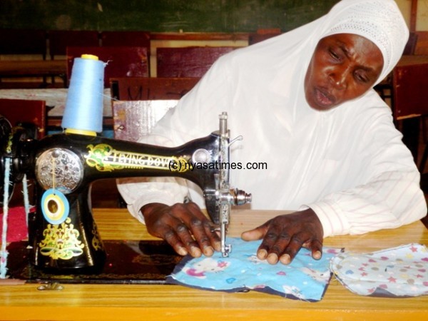 A participant from captured sewing a sanitary wear during a training.