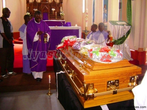 A priest at Catholic Institute blessing the casket with holy water____Photo Jeromy Kadewere