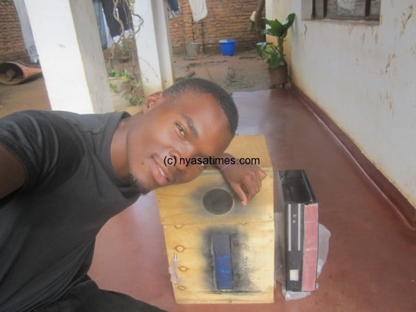 A smile of success, Zack Salawe Mwale with his nsima cooker when it was almost complete 