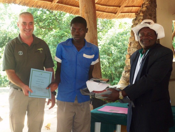 A student receives his award from TA Chapananga and a certificate from Hay-Pic by Steve Chirombo