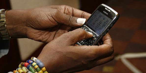 A woman browses the internet trough her mobile phone