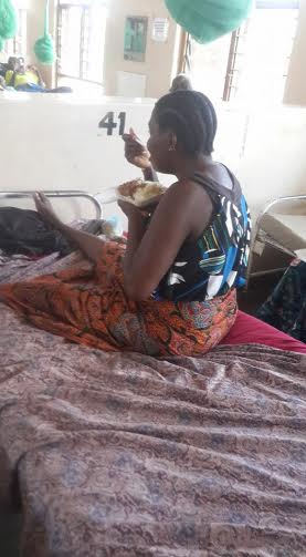A woman enjoying a meal she got -- Photo by Pius Nyondo, Nyasa Times