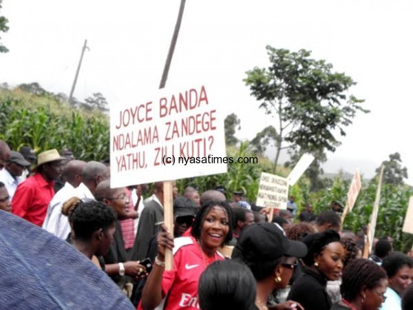A young lady carrying a placard asking President Joyce Banda to tell the nation where the money for the government Jet she sold went- Pic Lucky Mkandawire
