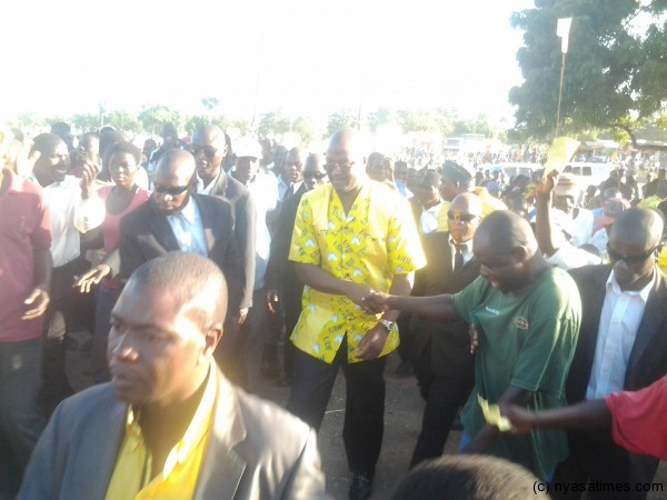 Atupele walking to the podium after arriving at the venue of the rally