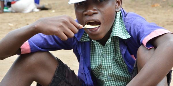 A_learner_eating_porridge_during_the_launch_of_the_school_feeding_program._pic_by_Felix_Washon[1]