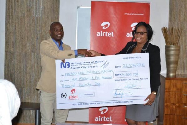 Airtel's Kamoto hand over cheque to NPL CEO Mbumba Banda