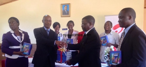 Airtel’s Regulatory Director Wilson Kyumba hands over the Tabs to Vice Chancellor of Malawi Adventist University Dr. Mozicie Kadyakapita Dr Kadyakapita