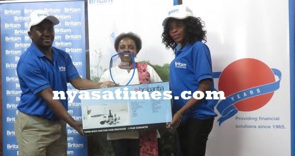 All for you- Bailey (middle) gets her trophy and prize from Britam officer