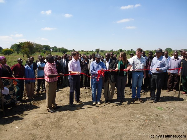 Alliance One Malawi officials opening the dam