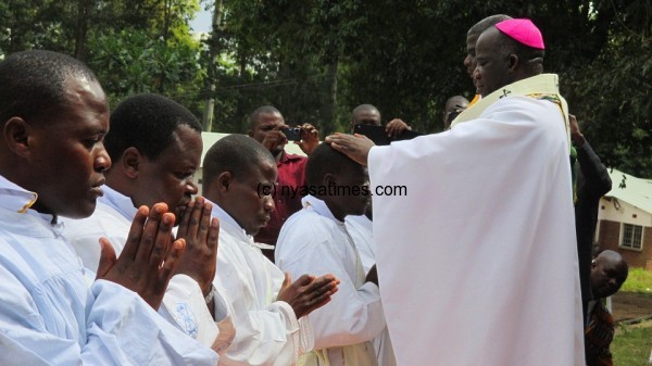 Archbishop Msusa blessing one of the ordained priests....Photo Jeromy Kadewere