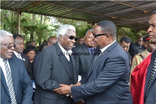 President Mutharika greets retired politician Gwanda Chakuamba as PP's Brown Mpinganjira looks on at the funeral