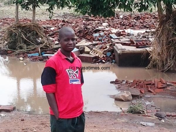 This boy whose Chigoli FP School in Mulanje was hit by the floods stands near his former home. Photo: Agnes Mizere