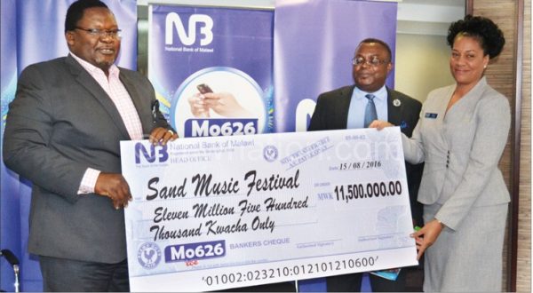 Banda (L) receiving the dummy cheque from National Bank of Malawi the Mo626