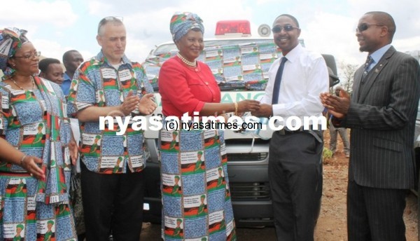 Presidential Advisor on Safe Motherhood, Madam Carista Mutharika, receives an Ambulance keys from UNC Project Assoc. Prof, Dr. Wilkinson and handover to the DHO, Dr. Mwale -Pic. by Abel Ikiloni