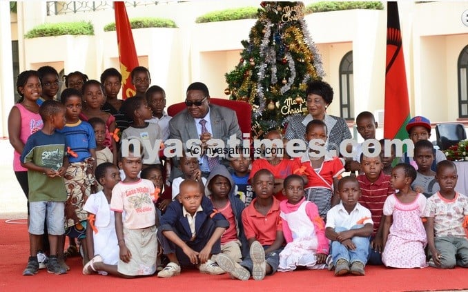 resident Peter Mutharika and first lady Gertrude Mutharika pose with children during a christmas party at Kamuzu Palace