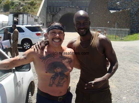 Eugene Khumbanyiwa (right) with renowned American actor Danny Trejo in Death Race 3 movie set. Photo ©Eugene Khumbanyiwa Facebook.
