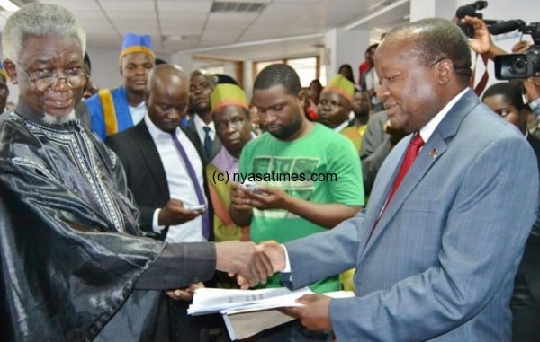 Chief Kyungu presenting petition to Chief Secretary Mkondiwa