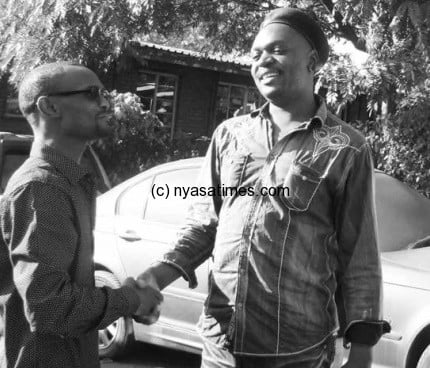 Ben Phiri (left) extends olive branch to Lemani at police station on Wednesday