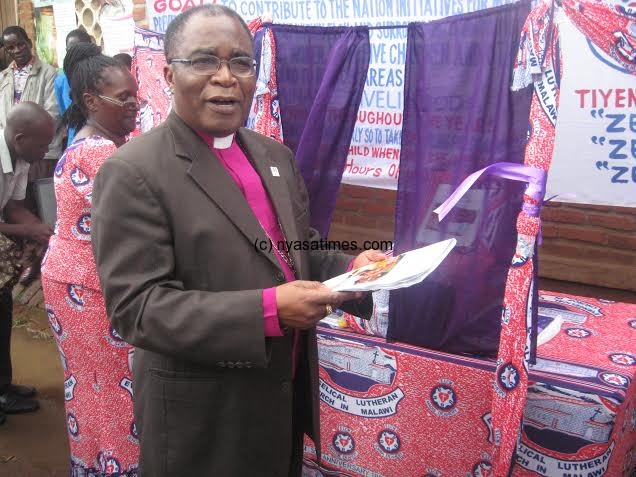 Bishop Bvumbwe holds the health policy document after the launch.