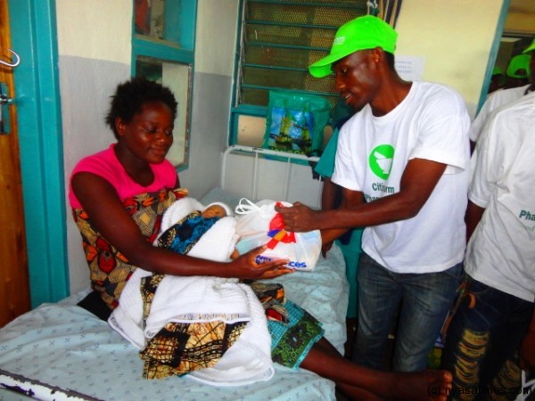 Blantyre United captain donating.....Photo Jeromy Kadewere