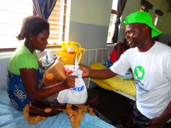 Blantyre United coach Elijah Kananji presenting a gift to a patient....Photo Jeromy Kadewere