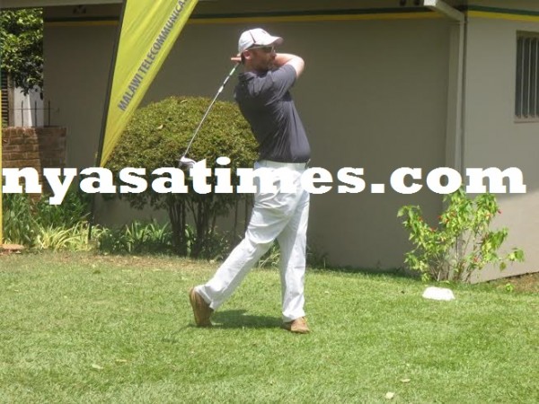 British High Commissioner to Malawi Michael Nevin watches his ball after teeing off.