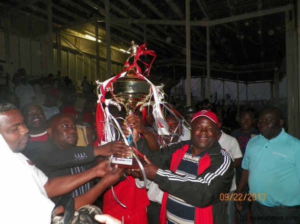 Bullets coach Eddie Ng'onamo and capt Fischer Kondowe hoist the trophy flanked by Luso TV MD Kendall Kamwendo, Pic Leonard Sharra, Nyasa Times