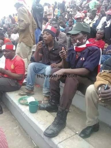 Lunch at stadium: Bullets supporters eating Nsima with bonya