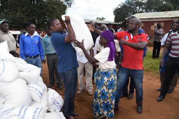 Bushiri helping a woman carry the maize home