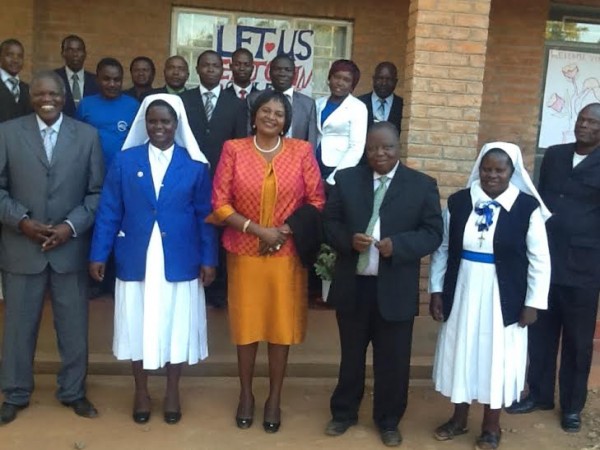 Callista pose for group photo at Nkhamenya Secondary school with school teachers