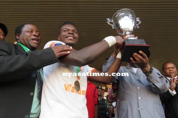 Captain Francis Mlimbika receiving the trophy -Photo Jeromy Kadewere