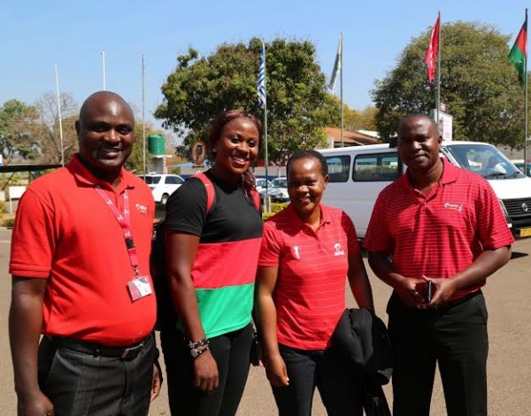 Malawi Queens captain Carol Ngwira posing with Airtel Officials...Photo Jeromy Kadewere